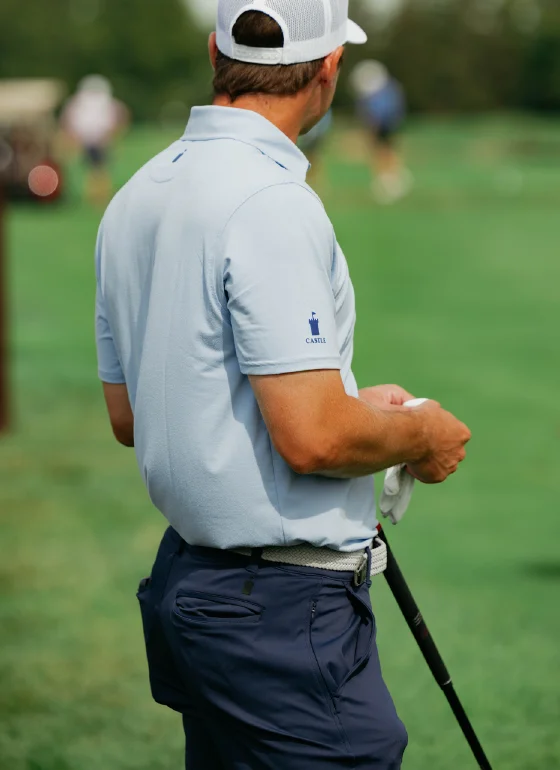 Golfer with Castle Golf Co. logo on sleeve and glove